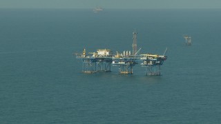 AF0001_000167 - HD aerial stock footage of a large oil platform in the Gulf of Mexico