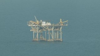 AF0001_000168 - HD aerial stock footage of flying by an oil platform in the Gulf of Mexico