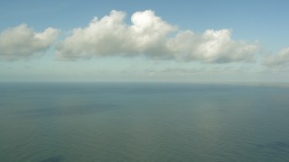 AF0001_000170 - HD aerial stock footage of flying over the Gulf of Mexico with a view of clouds near Matagorda Peninsula, Texas