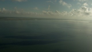 AF0001_000175 - HD aerial stock footage of a view across Matagorda Bay, Texas, with clouds overhead