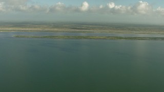 AF0001_000176 - HD aerial stock footage pan across the coast while flying over Matagorda Bay, Texas