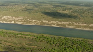 AF0001_000177 - HD aerial stock footage of flying over the grassy shore of Matagorda Bay, Texas