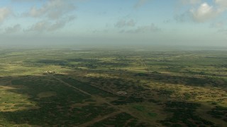 AF0001_000178 - HD aerial stock footage of flying over countryside to approach small farms and a country road, Matagorda County, Texas