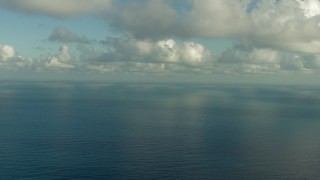 AF0001_000186 - HD aerial stock footage fly over the Gulf of Mexico and beneath clouds, and pan across the water