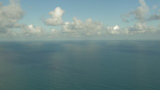 AF0001_000190 - HD aerial stock footage of passing the open water of the Gulf of Mexico with clouds overhead