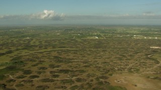 AF0001_000204 - HD aerial stock footage of flying by countryside, with farms and fields in the distance, Matagorda County, Texas
