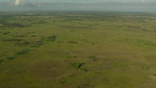 AF0001_000206 - HD aerial stock footage of flying by open countryside with farms in the background, Matagorda County, Texas