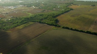 AF0001_000213 - HD aerial stock footage flyby farm fields to reveal a small town around a country road in Matagorda County, Texas