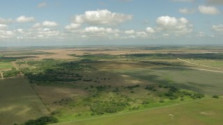 AF0001_000221 - HD aerial stock footage of passing by farms and fields in Wharton County, Texas