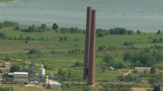 AF0001_000233 - HD aerial stock footage of smoke stacks at the Wharton County Generation power plant in Newgulf, Texas