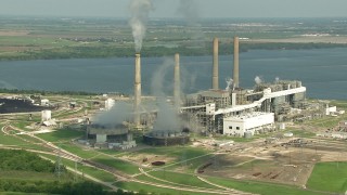 AF0001_000243 - HD aerial stock footage zoom to a wider view of WA Parish Generating Station and smoke stacks at Smithers Lake, Texas
