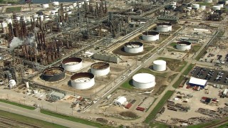 AF0001_000282 - HD aerial stock footage orbit oil refinery buildings and tanks in Harrisburg, Manchester, Texas