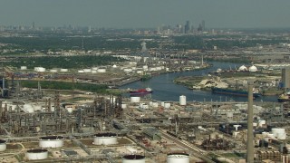 AF0001_000283 - HD aerial stock footage oil refineries around Buffalo Bayou in Harrisburg, Manchester, Texas, Downtown Houston skyline in background