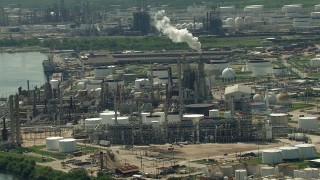 AF0001_000287 - HD aerial stock footage approach an oil refinery by the river in Galena Park, Texas