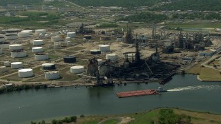 AF0001_000290 - HD stock footage aerial video flyby a barge sailing Buffalo Bayou past an oil refinery in Pasadena, Texas