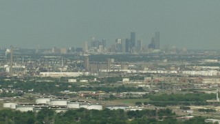 AF0001_000296 - HD aerial stock footage of the city skyline seen from oil refineries in Pasadena, Downtown Houston, Texas