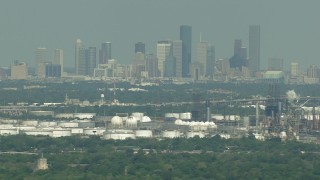 AF0001_000297 - HD aerial stock footage of Downtown Houston skyline seen from oil refineries in Harrisburg, Manchester, Texas