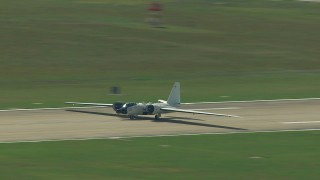 AF0001_000299 - HD aerial stock footage of tracking a military jet readying for takeoff, Ellington Airport, Houston, Texas