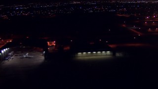 AF0001_000302 - HD aerial stock footage flyby airplane hangars at night at Ellington Airport, Houston, Texas