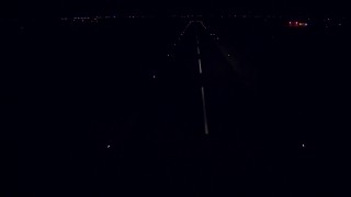 AF0001_000315 - HD aerial stock footage approach the runway and descend for a landing at Calhoun County Airport, Port Lavaca, Texas, night