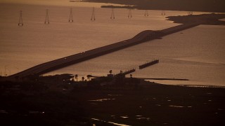 AF0001_000318 - HD aerial stock footage of the Lavaca Bay Causeway with light traffic in Port Lavaca, Texas, sunrise
