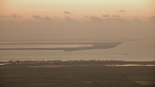 AF0001_000323 - HD aerial stock footage of a view of marshland across Matagorda Bay, Texas, sunrise