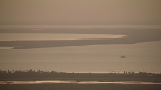 AF0001_000324 - HD aerial stock footage flyby Matagorda Bay at sunrise, and zoom in to a closer view, Texas