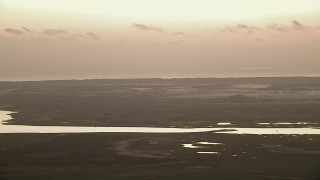 AF0001_000327 - HD aerial stock footage of wetlands on the shore of Powderhorn Lake at sunrise, Texas