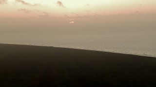 AF0001_000336 - HD aerial stock footage of the rising sun visible from marshland by Gulf of Mexico, sunrise