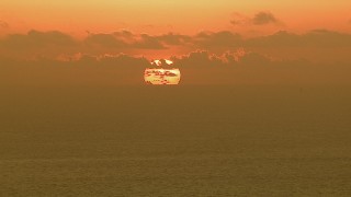 AF0001_000337 - HD aerial stock footage of the sun rising behind clouds over the Gulf of Mexico