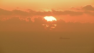 AF0001_000338 - HD aerial stock footage of the sun rising behind clouds over oil tankers in the Gulf of Mexico