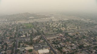 AF0001_000364 - HD aerial stock footage of neighborhoods near Whiteman Airport in Pacoima, California