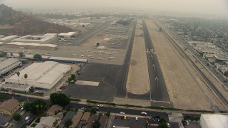 AF0001_000366 - HD aerial stock footage of approaching the runway at Whiteman Airport, Pacoima, California
