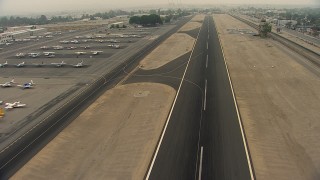 AF0001_000367 - HD aerial stock footage fly over the airport runway at Whiteman Airport, Pacoima, California