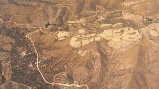 AF0001_000395 - HD aerial stock footage tilt to a bird's eye view of rock formations near Agua Dulce, California
