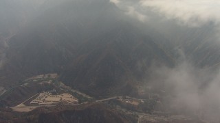AF0001_000407 - HD aerial stock footage fly over clouds to reveal a ranch by Big Tujunga Canyon Road, Tujunga, California