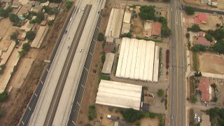 AF0001_000415 - HD aerial stock footage of bird's eye view of greenhouses and homes by the 210 Freeway, Lake View Terrace, California