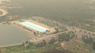 AF0001_000417 - HD aerial stock footage of flying by Hansen Dam Aquatic Center in Lake View Terrace, California