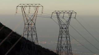 AF0001_000482 - HD aerial stock footage zoom in and track three power line towers in the San Gabriel Mountains, California