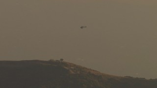 AF0001_000516 - HD aerial stock footage of tracking helicopter flying over Verdugo Mountains, Tujunga, California, twilight