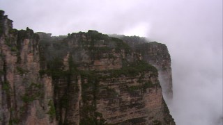 AF0001_000600 - HD aerial stock footage flyby steep mountain cliffs in the rain in Southern Venezuela