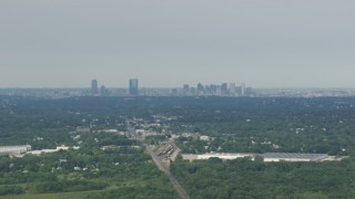 AF0001_000695 - HD aerial stock footage of a view of Downtown Boston, seen from warehouse buildings in Readville, Massachusetts