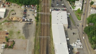 AF0001_000700 - HD aerial stock footage of a bird's eye view of train tracks through Hyde Park, Massachusetts