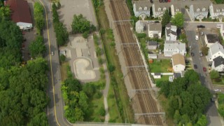 AF0001_000701 - HD aerial stock footage of a bird's eye view of train tracks, reveal soccer field in Hyde Park, Massachusetts