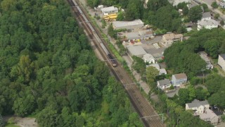 AF0001_000703 - HD aerial stock footage of a commuter train running through Hyde Park, Massachusetts