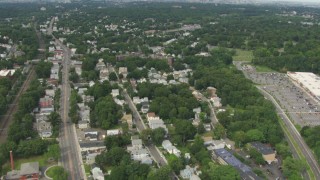 AF0001_000704 - HD aerial stock footage tilt from homes in Hyde Park to reveal the skyline of Downtown Boston, Massachusetts