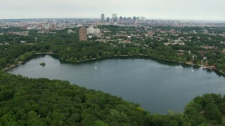 AF0001_000710 - HD aerial stock footage flyby Jamaica Plain homes with a view of Downtown Boston, reveal Jamaica Pond, Massachusetts
