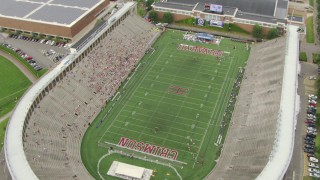 AF0001_000721 - HD aerial stock footage orbit Harvard Stadium with fans in the stands at Harvard University, Cambridge, Massachusetts