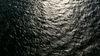 AF0001_000818 - HD aerial stock footage of a bird's eye view of light reflecting off the calm Atlantic Ocean