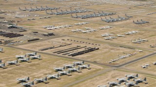 AF0001_000862 - HD aerial stock footage of groups of military airplanes at the base's aircraft boneyard, Davis Monthan AFB, Tucson, Arizona